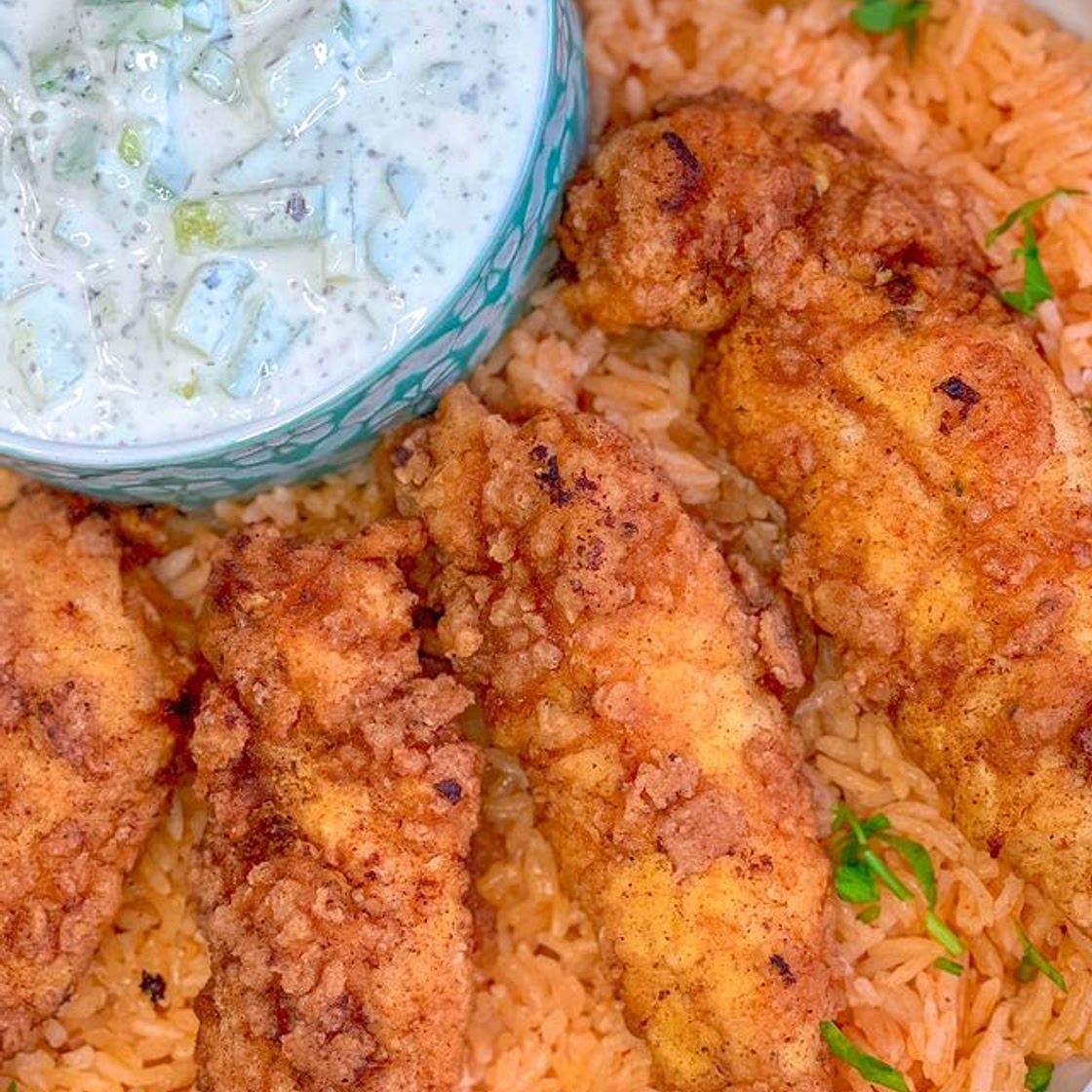 Fried chicken tenders with red rice and cucumber yogurt salad