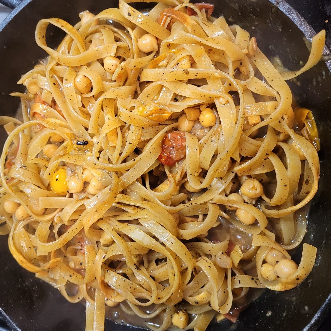 Fried Tagliatelle with Chickpeas and Tomatoes in Cajun Oil