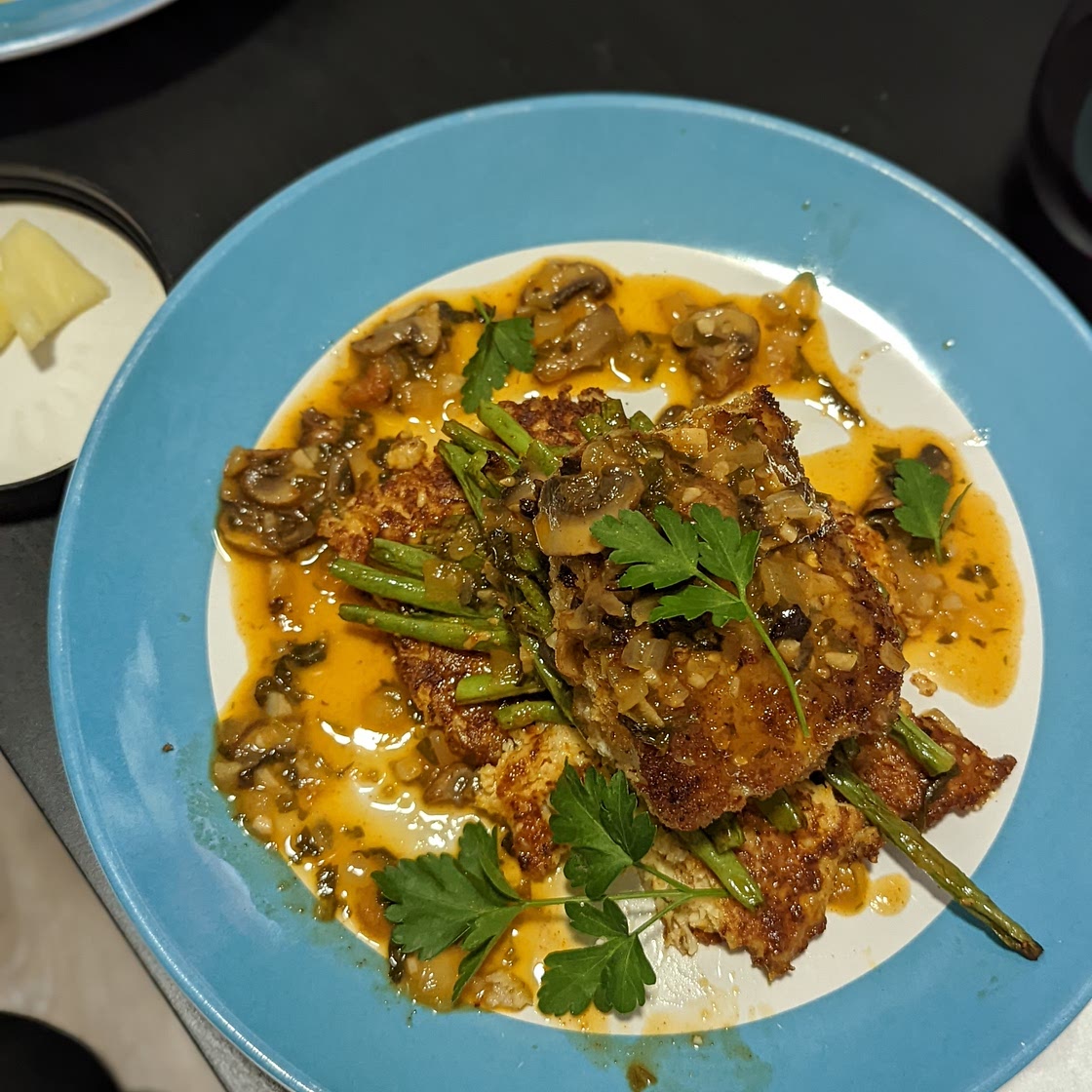 Panko Cod with Truffle Mushroom Sauce served over Cauliflower Fritters and Green Beans