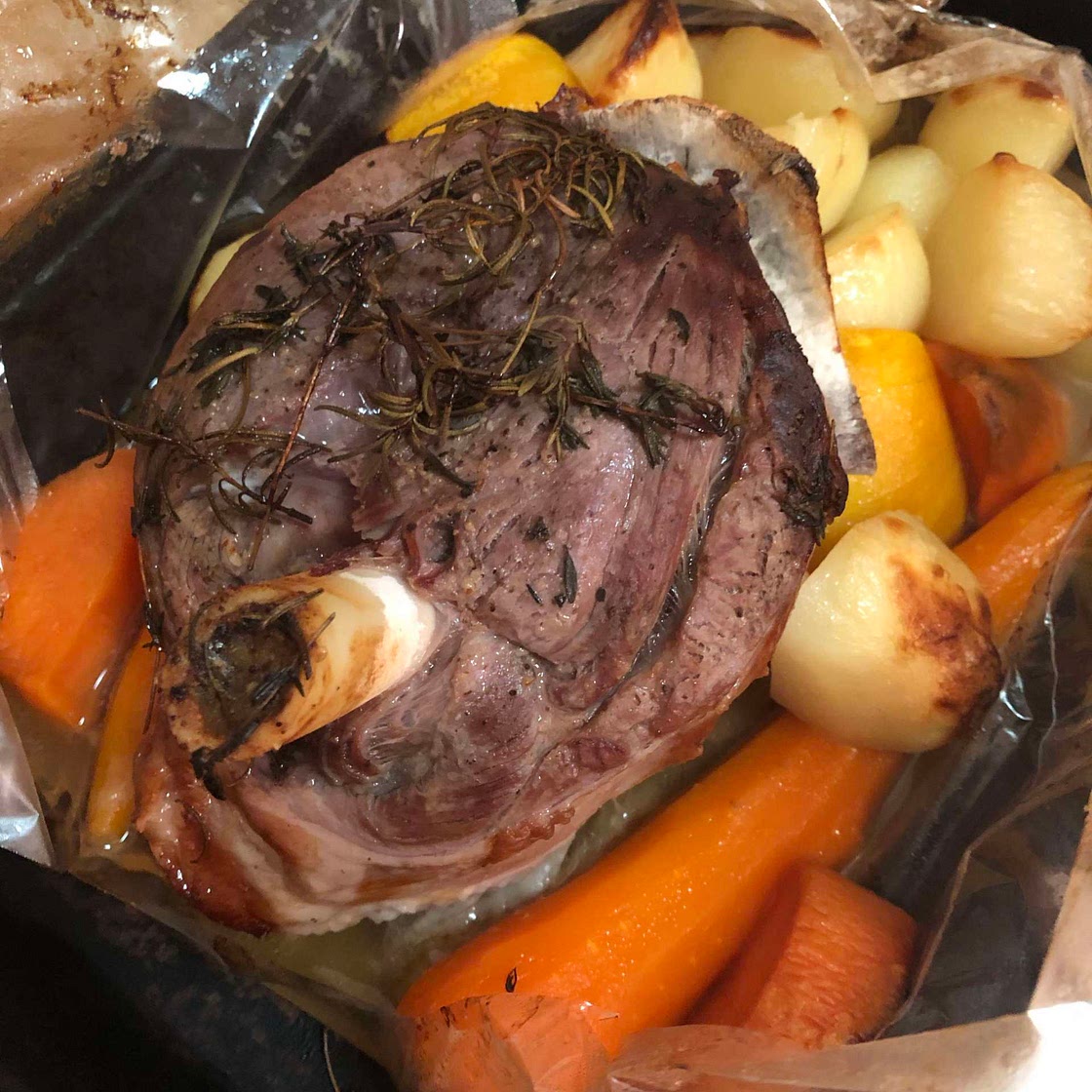 Roast lamb with rosemary and thyme in an oven bag