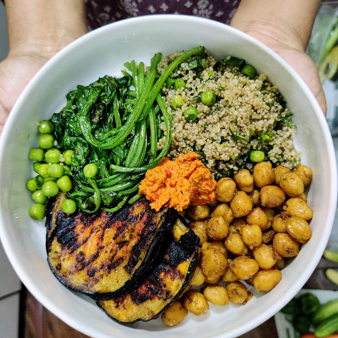 Buddha bowl with basil pea quinoa, romesco aubergine, chickpeas and spinach