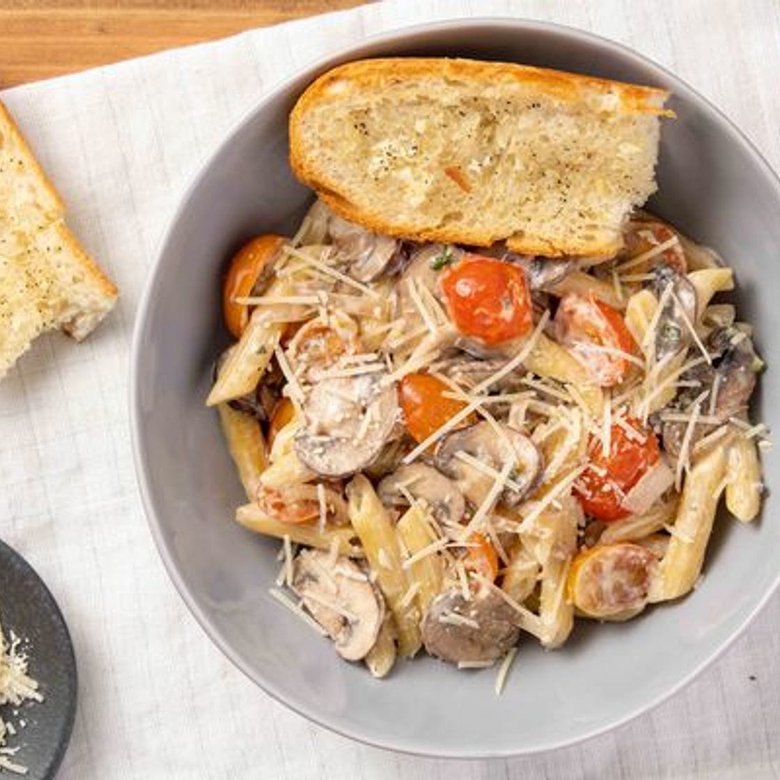 Mushroom Parmesan Penne Pasta with oregano and baguette