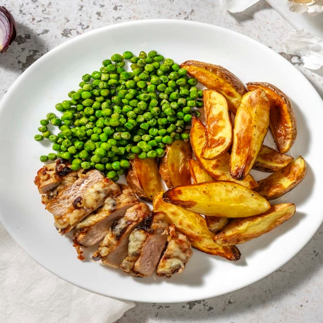 Cheese and Caramelised Onion Pork Steaks with Wedges and Peas