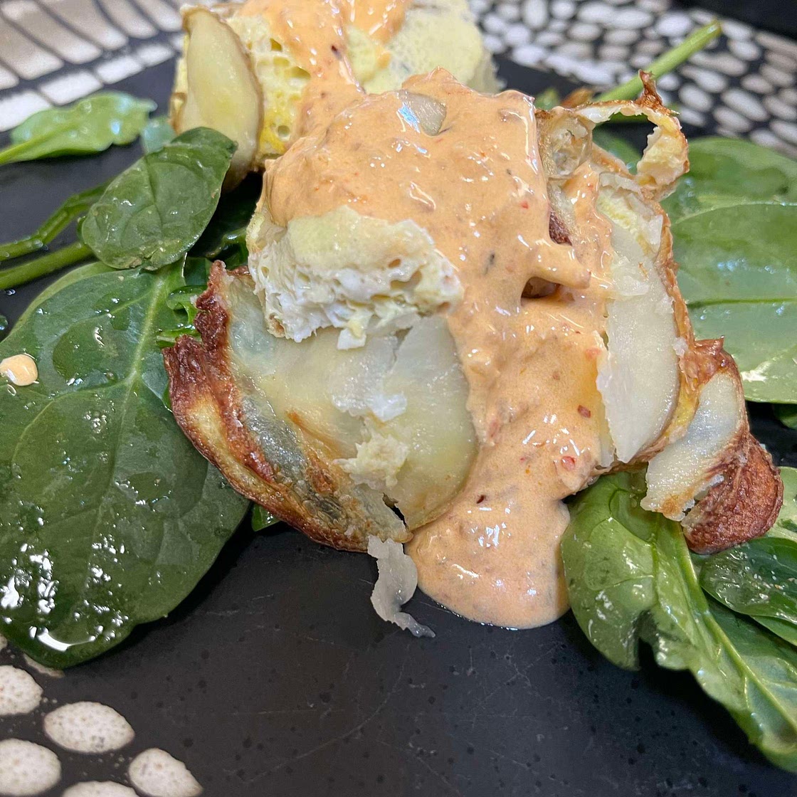 Egg, sausage, potato breakfast with chili-sour cream sauce