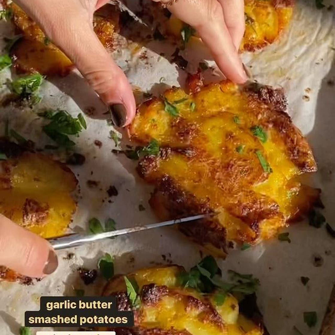 crispy smashed potatoes, recipe below 1 head garlic 1 tbsp olive oil 1kg baby white potatoes 90g butter 2 1/2 tbsp olive oil, extra Salt, to taste 2 tbsp parsley, finely chopped. Preheat oven to 200C. Chop the top off the head of garlic. Place on top of a 