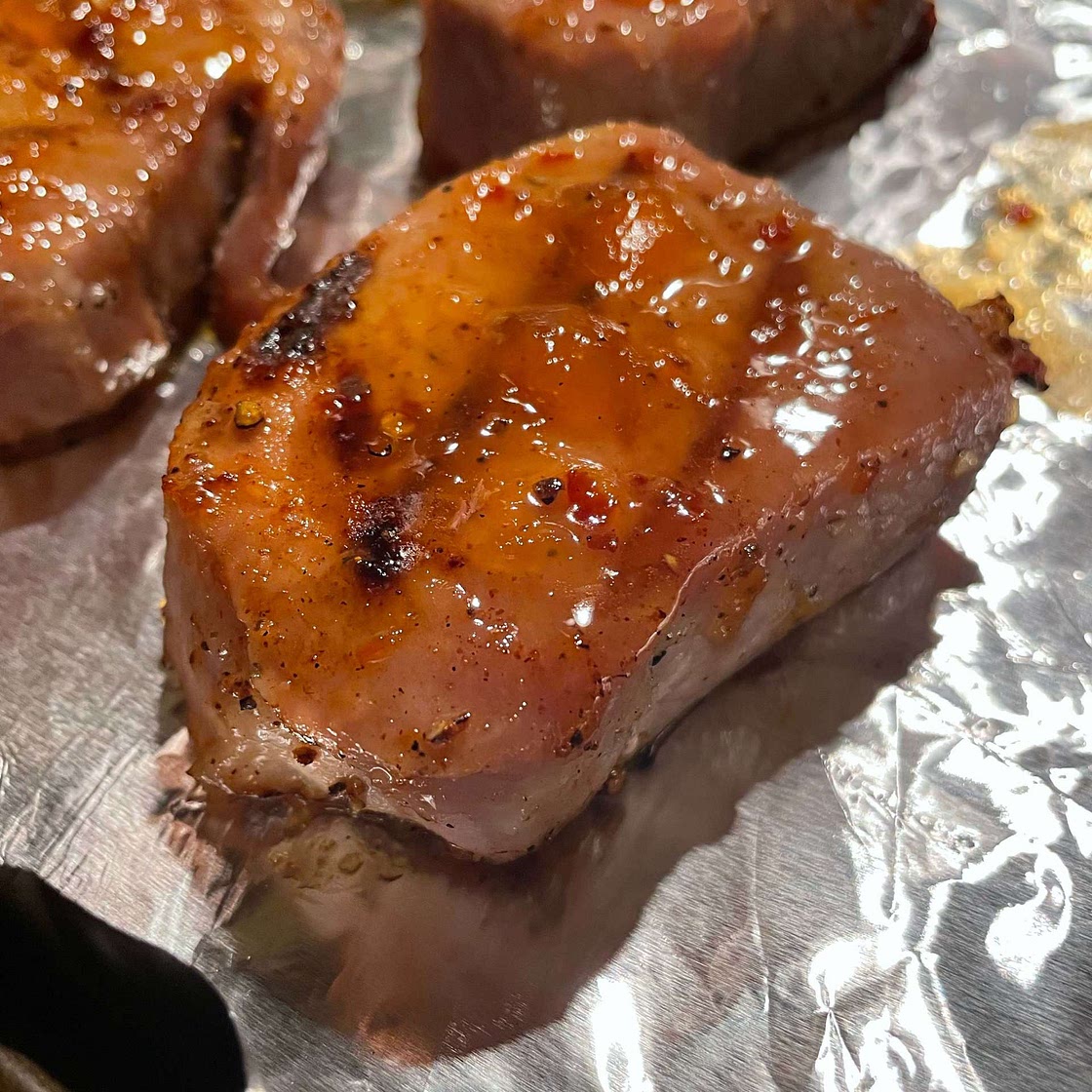 Juicy Grilled Pork Chops with Spicy Peach Glaze
