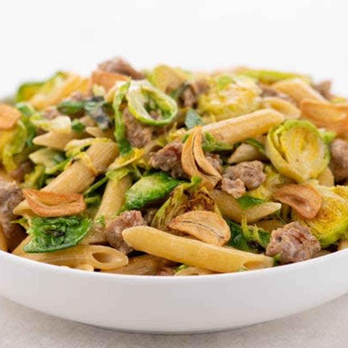 Italian Sausage Pasta with Brussels Sprouts and garlic chips