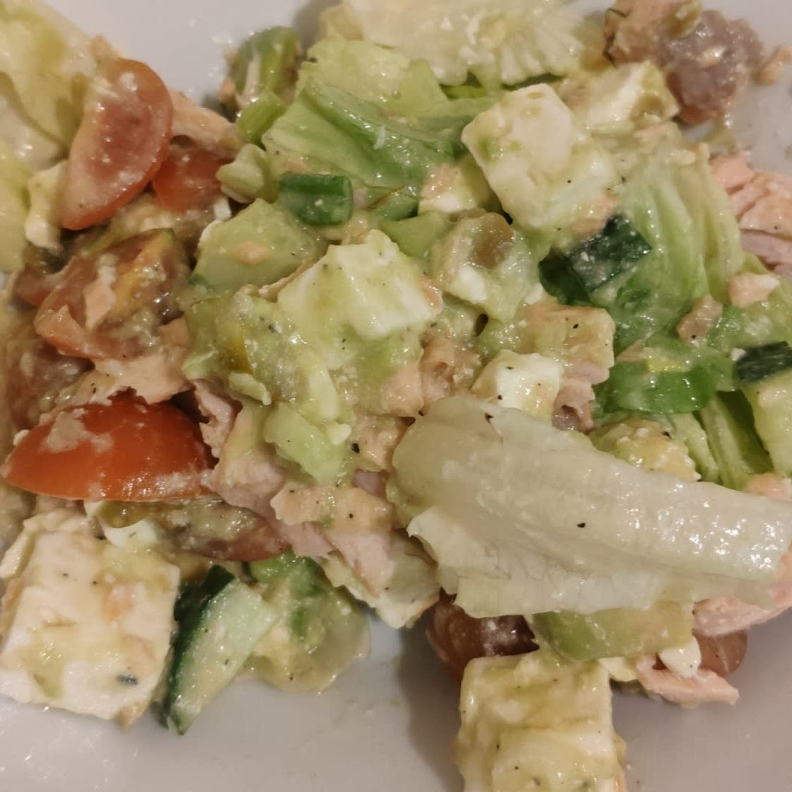 Salmon salad with feta cheese and avocado dressing
