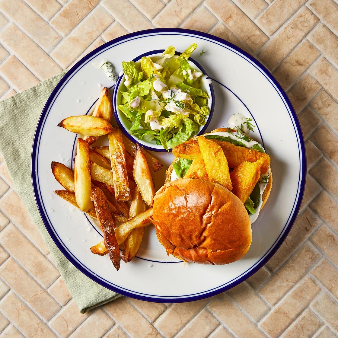 Posh fish finger sandwich with chips, crunchy gem and dill mayo