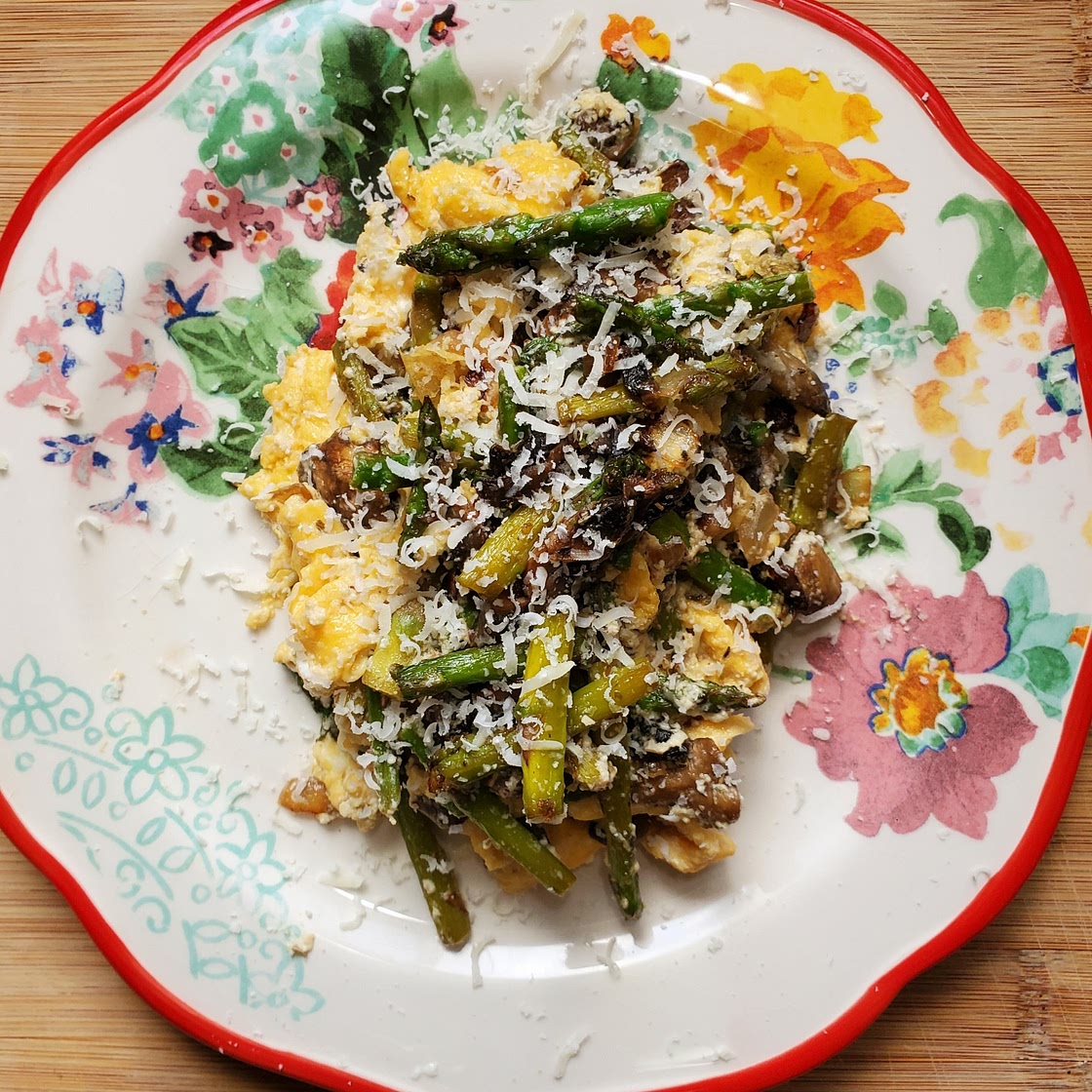 Scrambled eggs with asparagus, mushrooms, and ricotta.