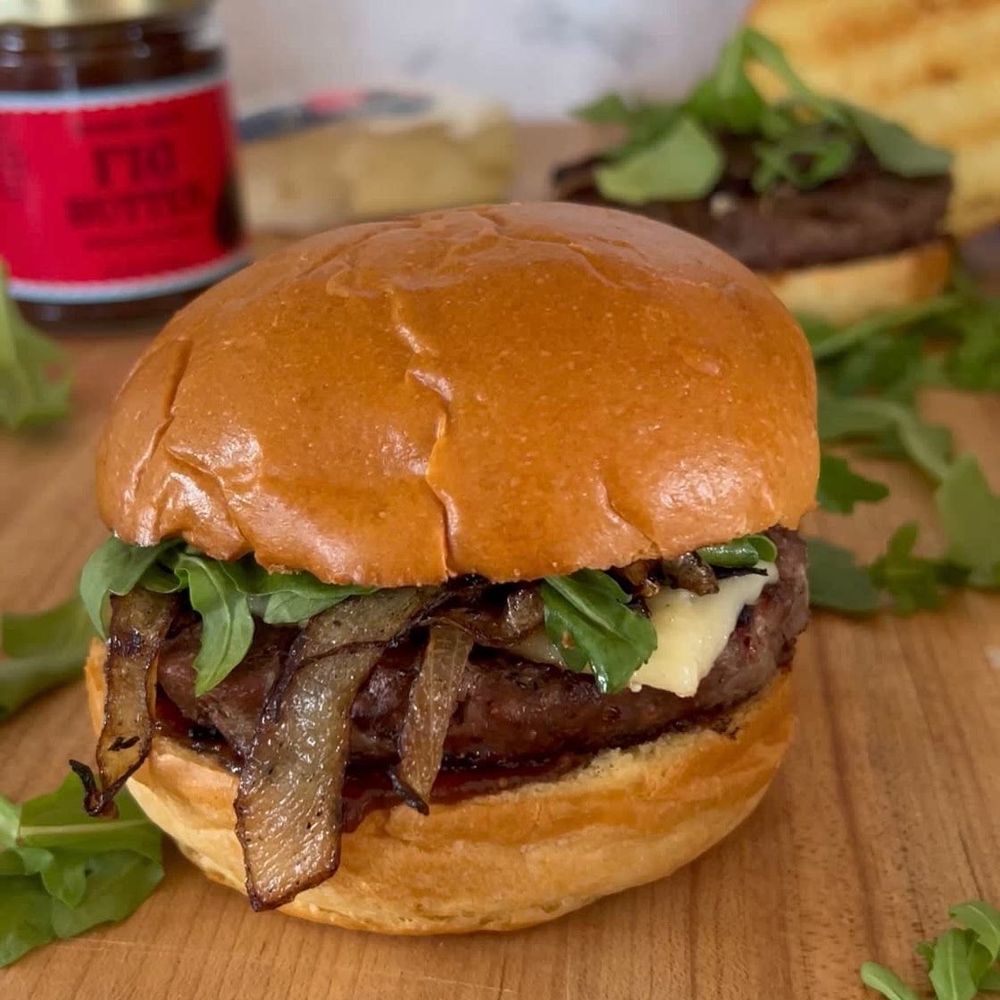 Fig Butter Burger with Brie, Caramelized Onions, and Arugala