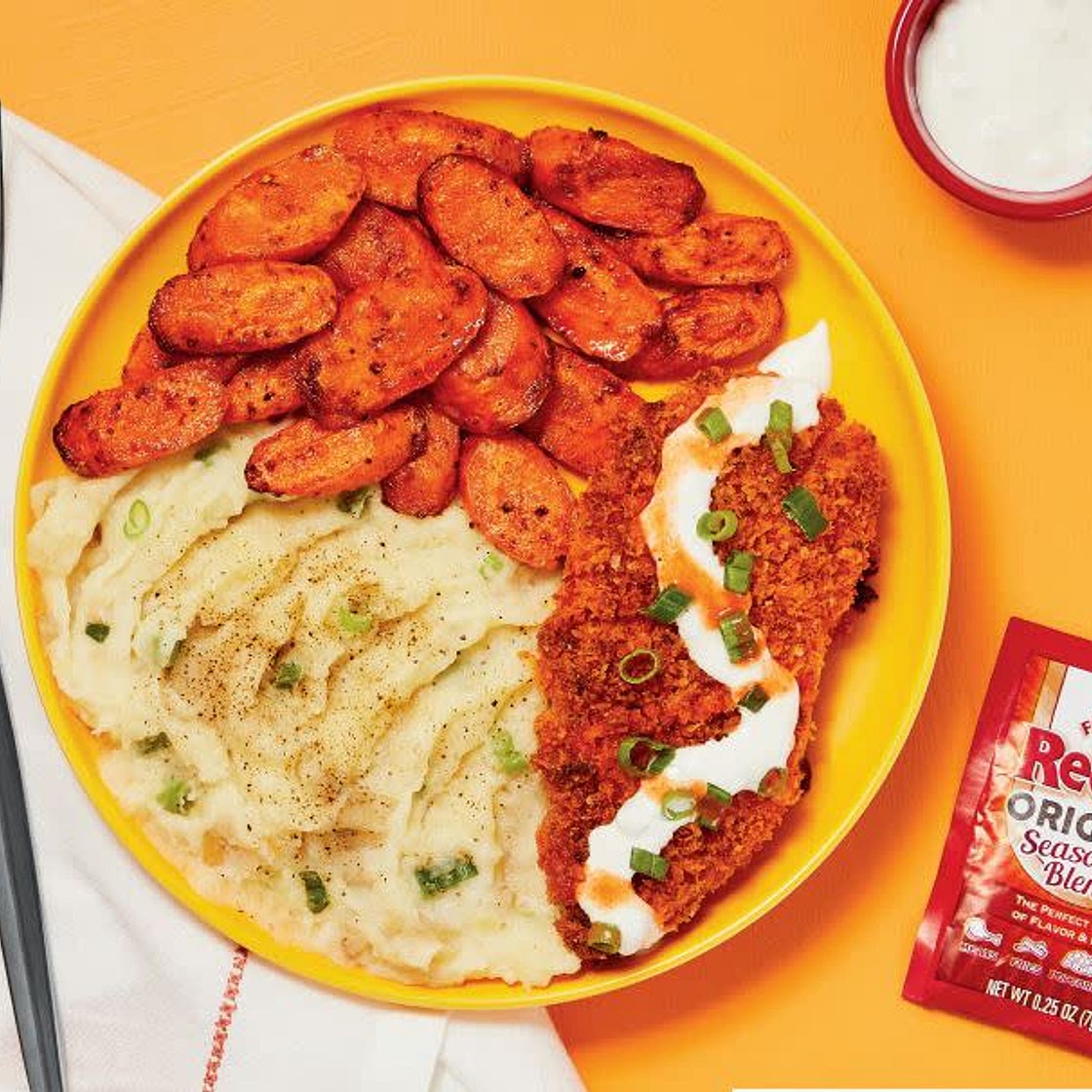 Crispy Frank’s RedHot®-Spiced Chicken with Blue Cheese Sauce, Scallion Mashed Potatoes & Carrots
