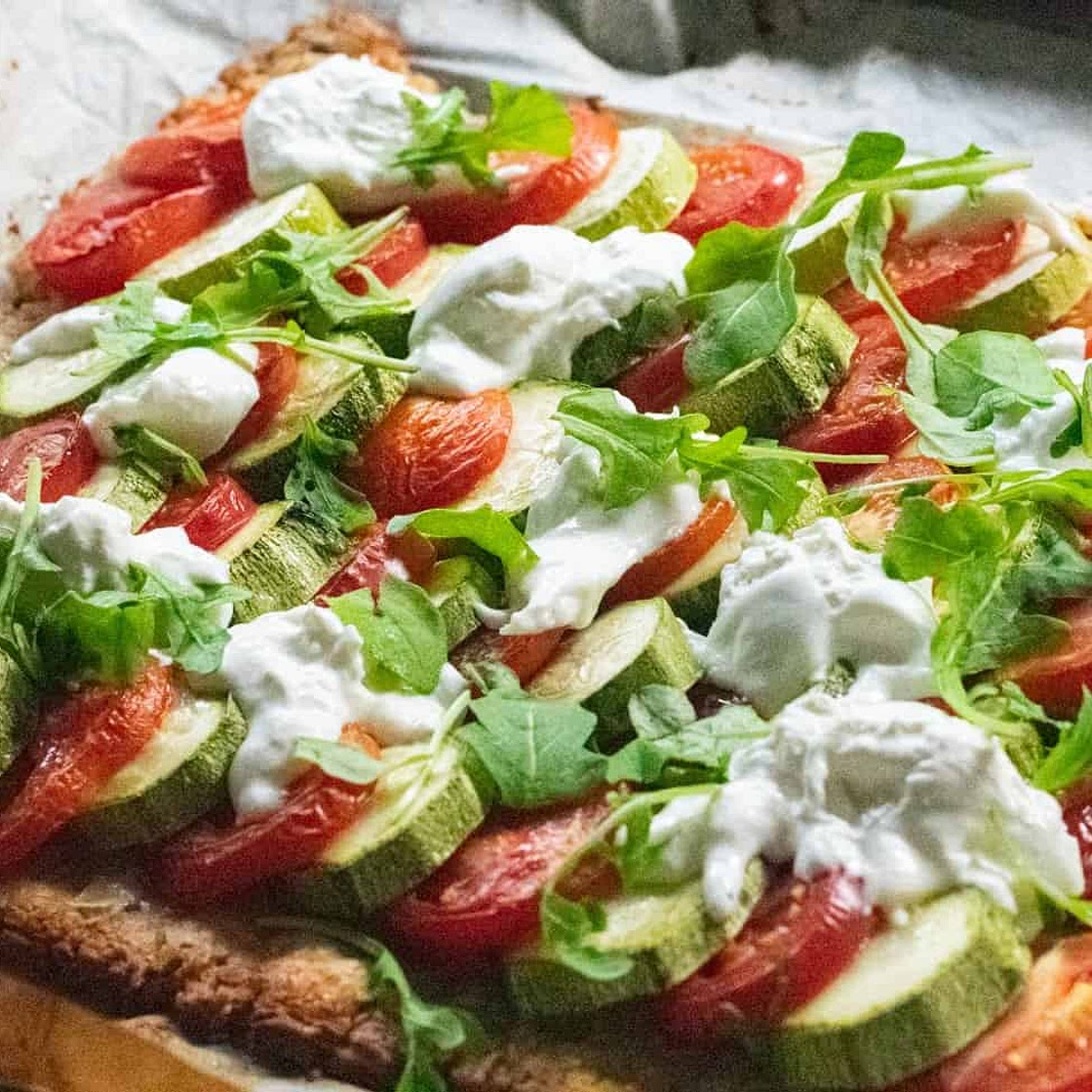Courgette and tomato tart with burrata and rocket