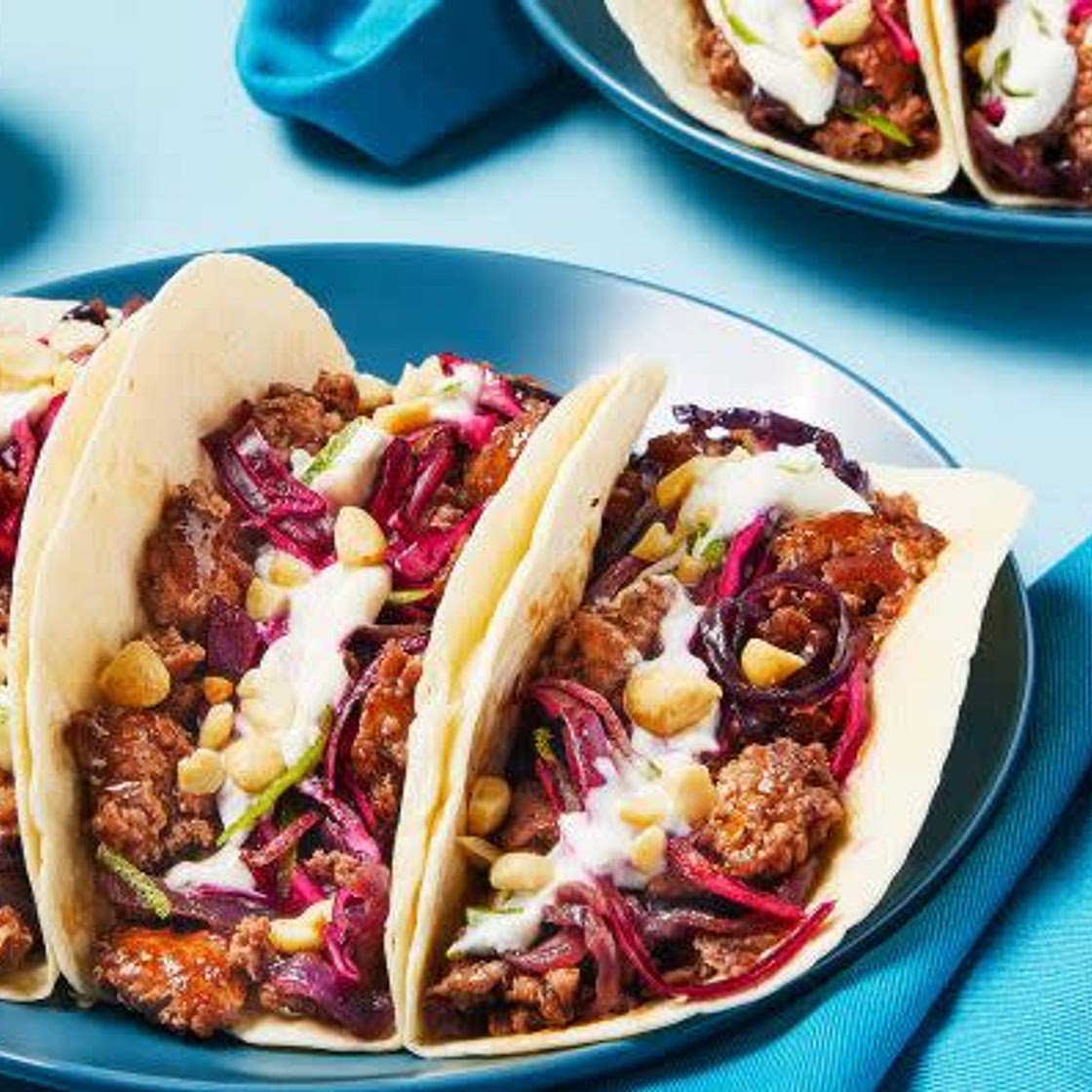 Sweet Chili Pork Tacos with Red Cabbage Slaw, Zesty Crema & Peanuts