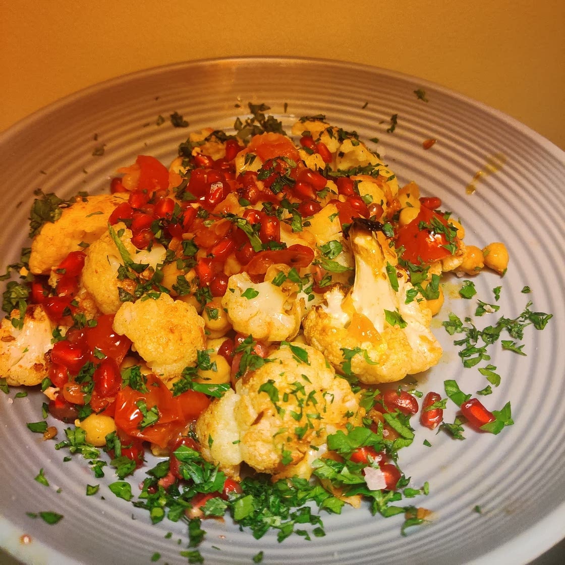 Warm spiced cauliflower and chickpea salad with pomegranate seeds