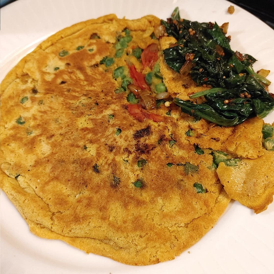 Pudla with spicy spinach