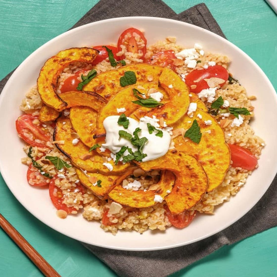 Harissa Roasted Sweet Potato on Mint Tabbouleh with Cheese, Flaked Almonds and Yoghurt