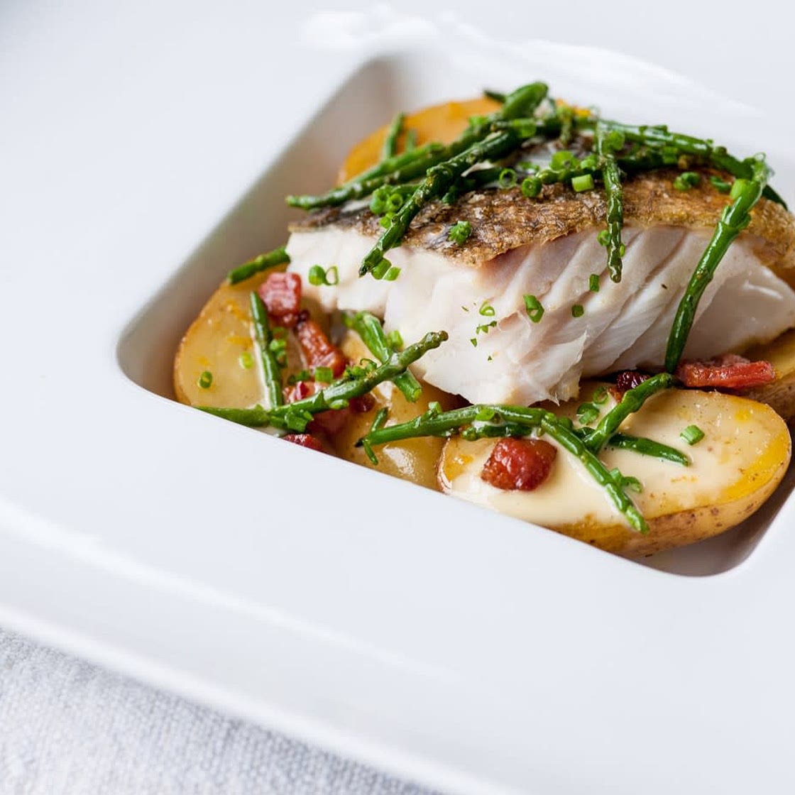 Pan Roasted cod with confit Jersey royals with pancetta