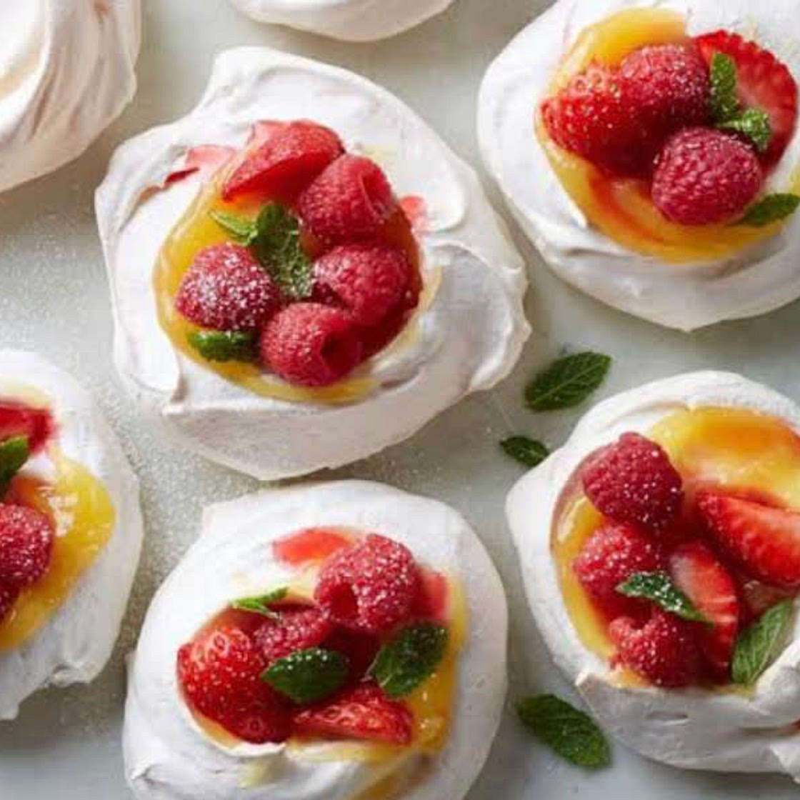 Pavlova shells, berries and custard 