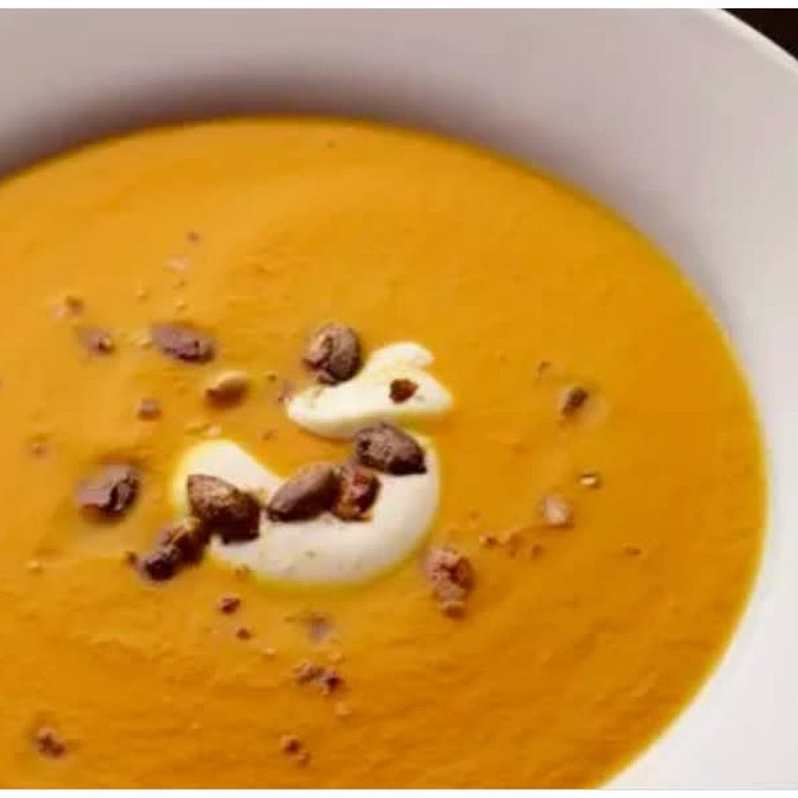 Pumpkin, saffron & orange soup with caramelised pumpkin seeds