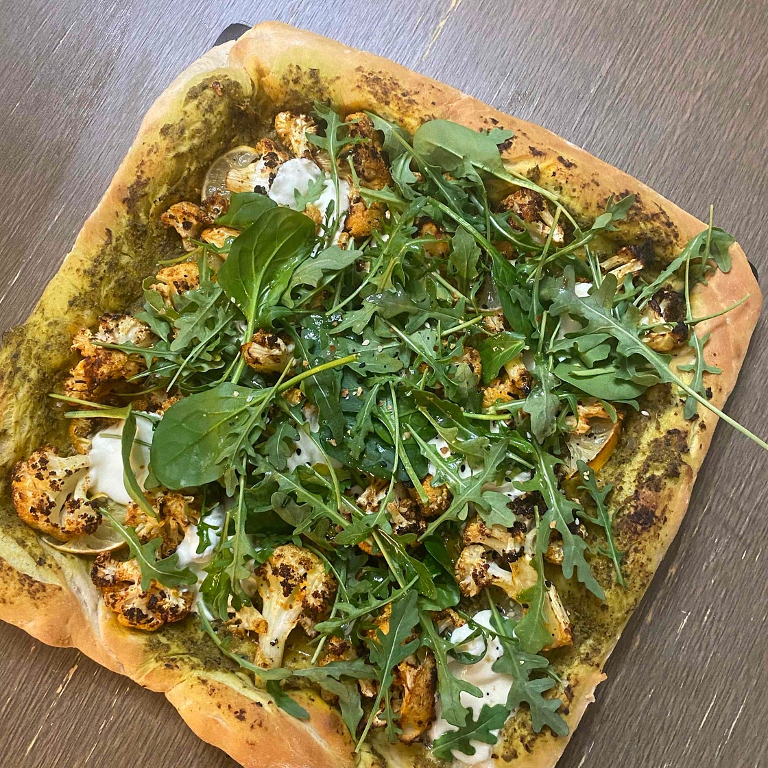 Cauliflower and lemon pesto pizza with baby greens