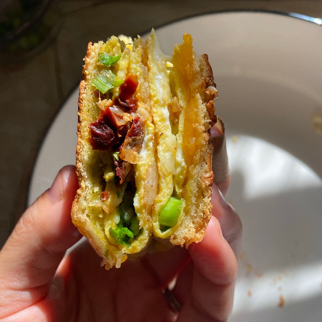  Breakfast sandwich with sundried tomatoes, spinach, and cheese.