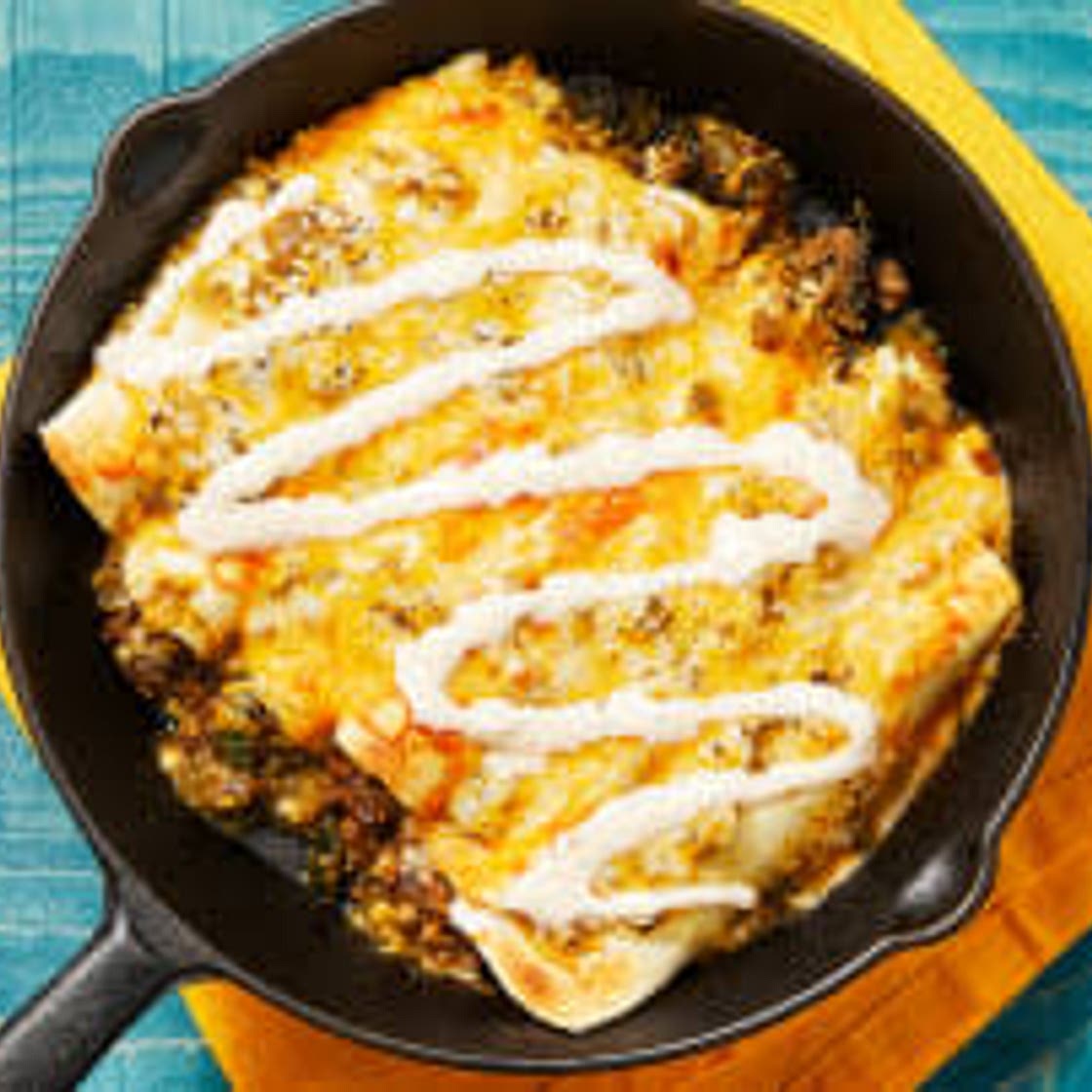 One-Pan Beef Enchiladas Verdes with Mexican Cheese Blend & Hot Sauce Crema