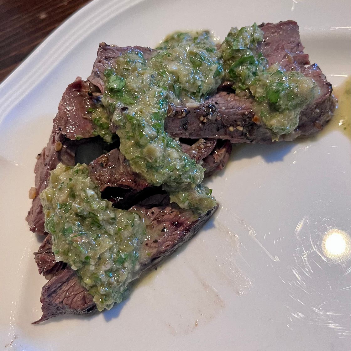 Sliced skirt steak with parsley caper sauce