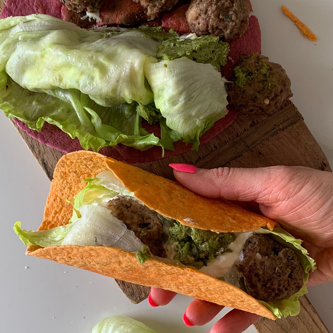 Greek meatballs with pea-pistachio pesto in colorful wraps