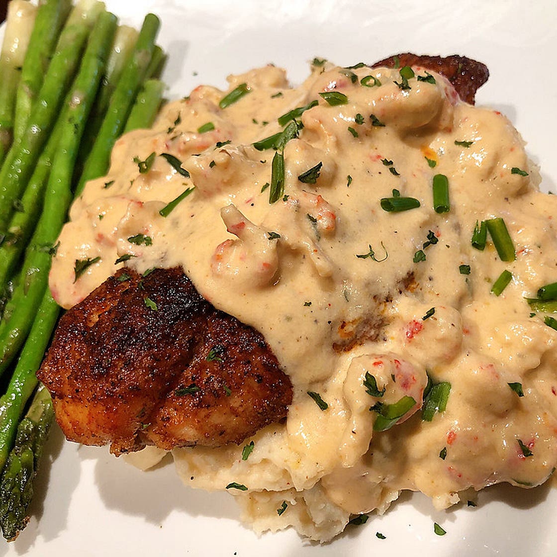 BLACKENED CATFISH TOPPED WITH A CRAWFISH CREAM SAUCE