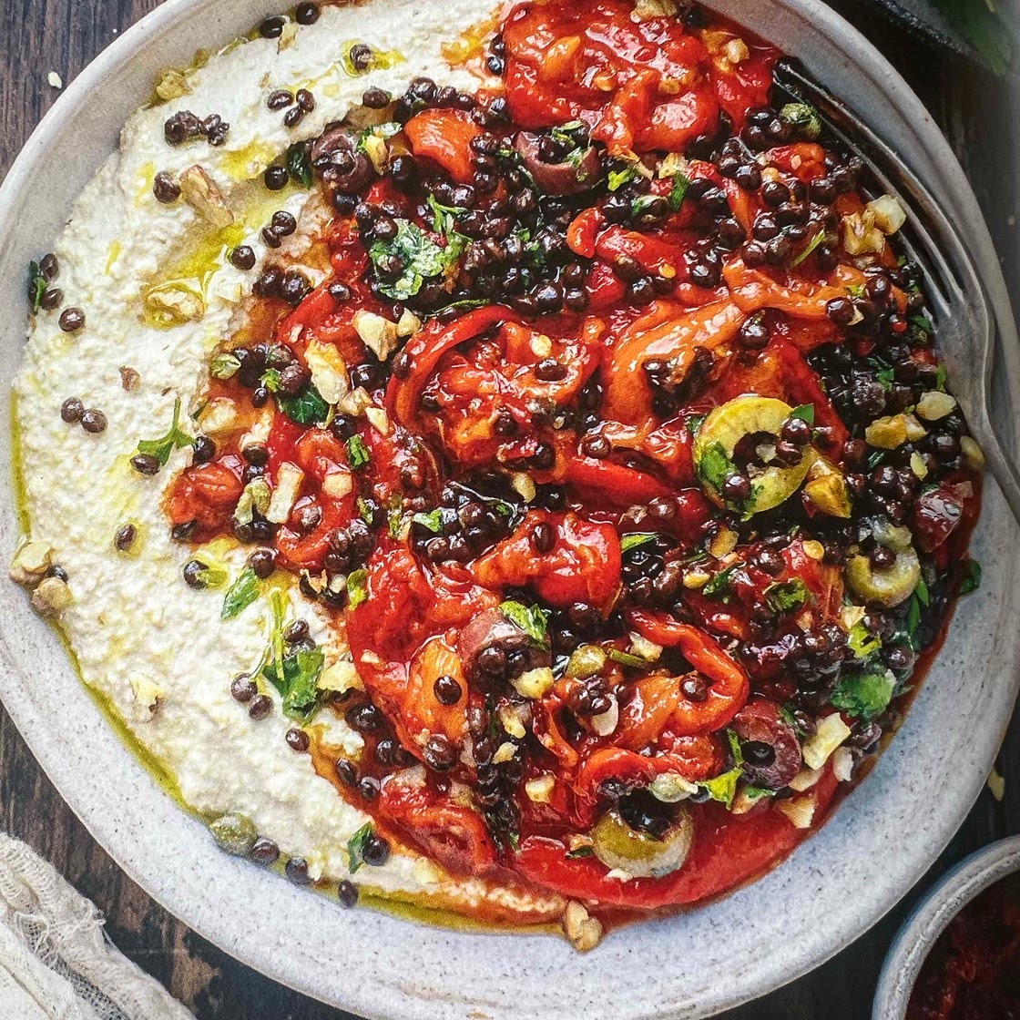 Hummus bowl with harissa pepper and olive gremolata