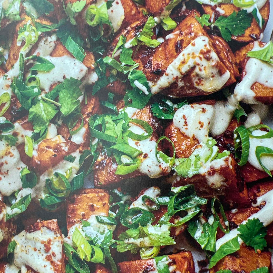Harissa sweet potatoes with roasted garlic & tahini dressing