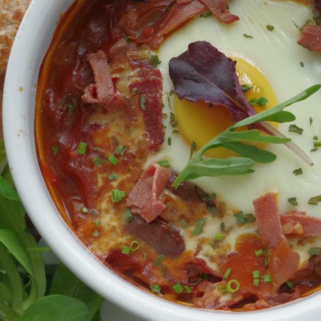 Fava bean stew topped with a baked egg