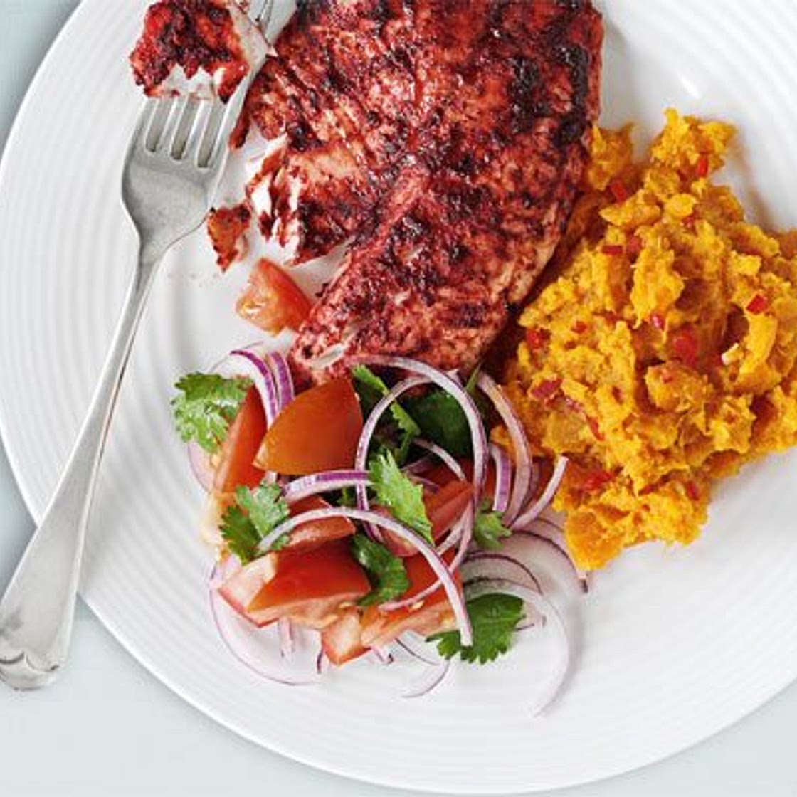 Tandoori tilapia with spicy sweet potato mash & tomato salad