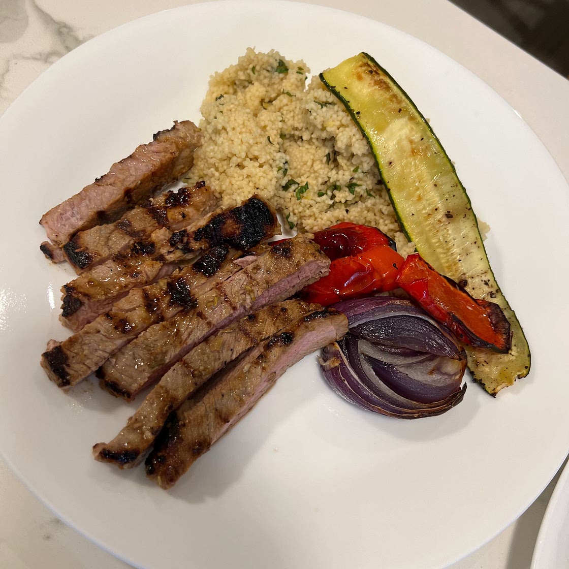 Garlic-Glazed Scotch Fillet Pork with Roasted Vegetables and Herbed Couscous