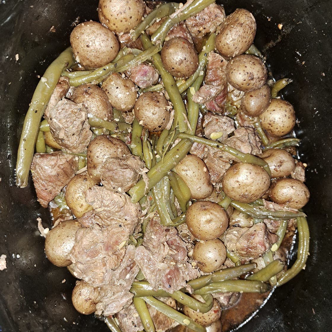 Garlic Steak Bites with Green beans and mini gold potatoes in the slow cooker.