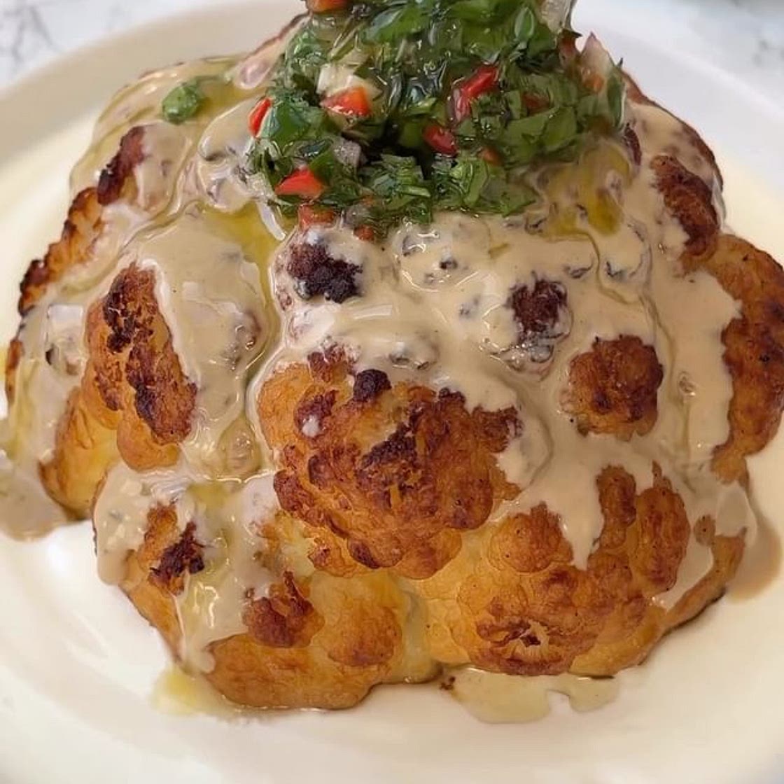 Roasted cauliflower with garlicky yoghurt, served with tahini an