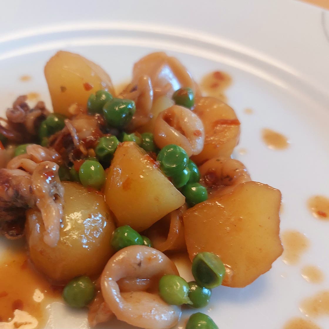 Cuttlefish with potatoes, peas and chili