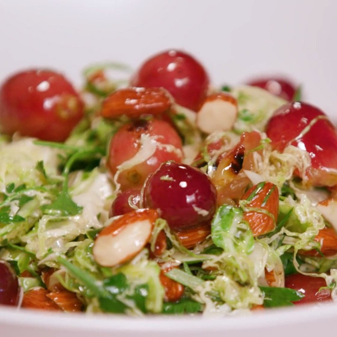Shaved Brussels Sprouts with Charred Grapes and Toasted Almonds