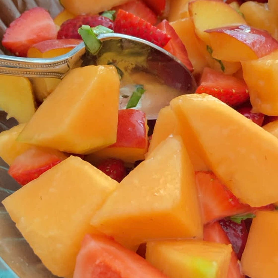 Summer fruit salad with basil lime dressing