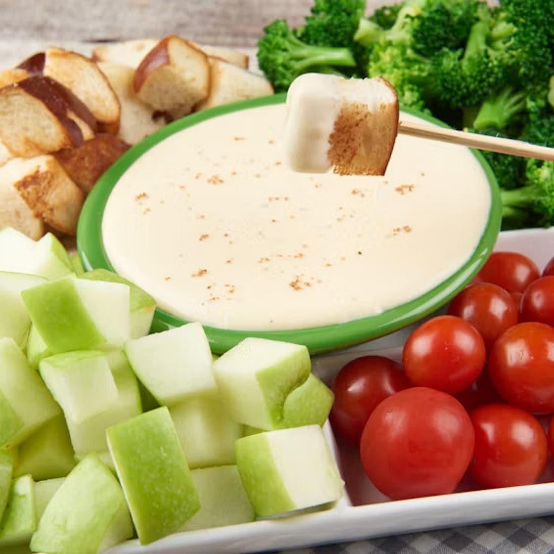 Swiss Fondue With Pretzel Bread, Broccoli, Tomatoes, and Apples