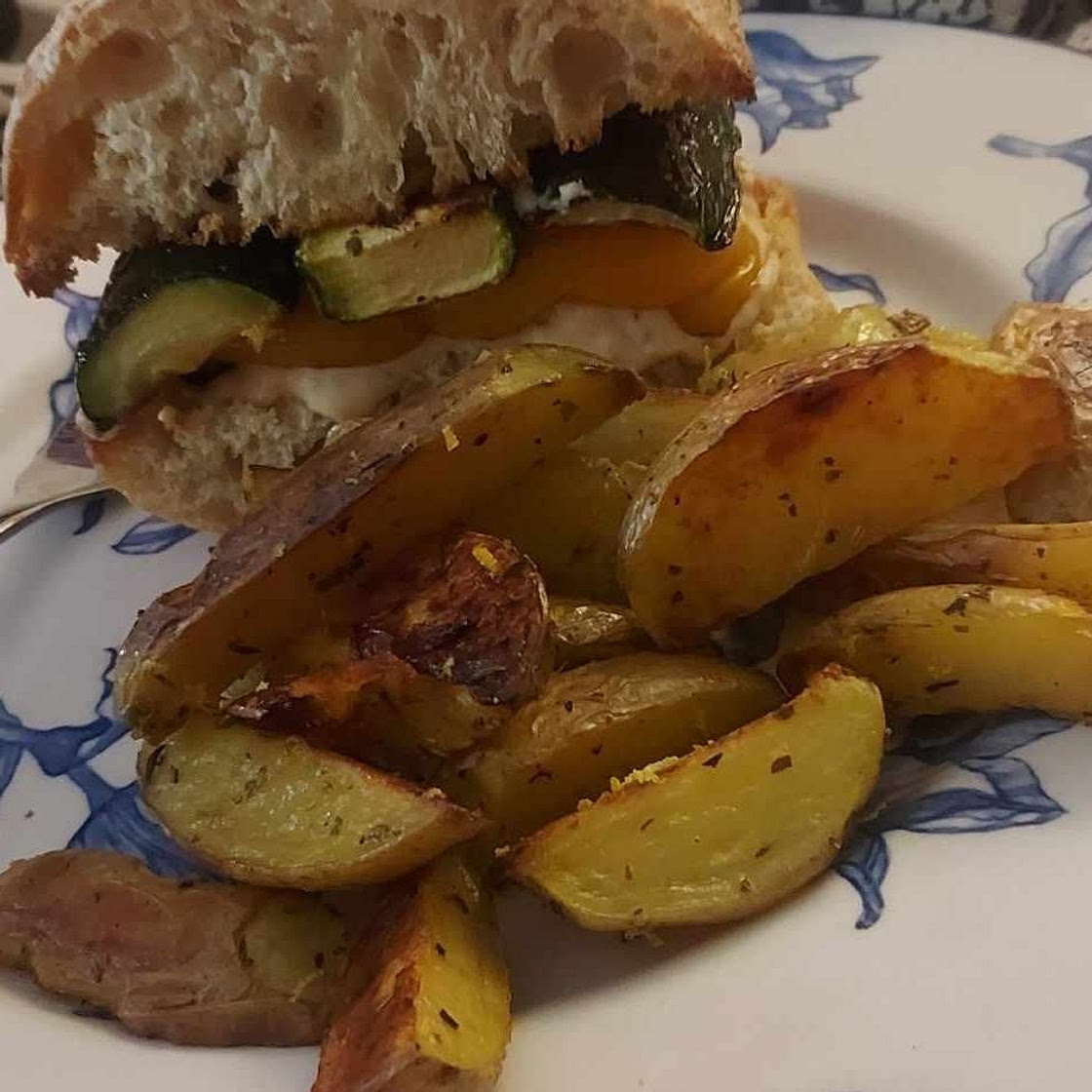 Mediterranean Roasted Veggie Sandwiches with feta, creamy hummus sauce, and lemon herb potato wedges