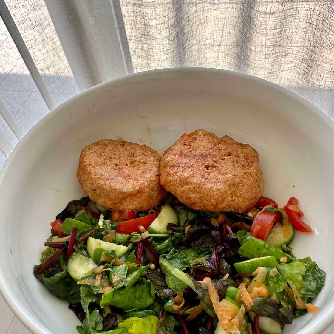 Salmon cakes on mixed greens 
