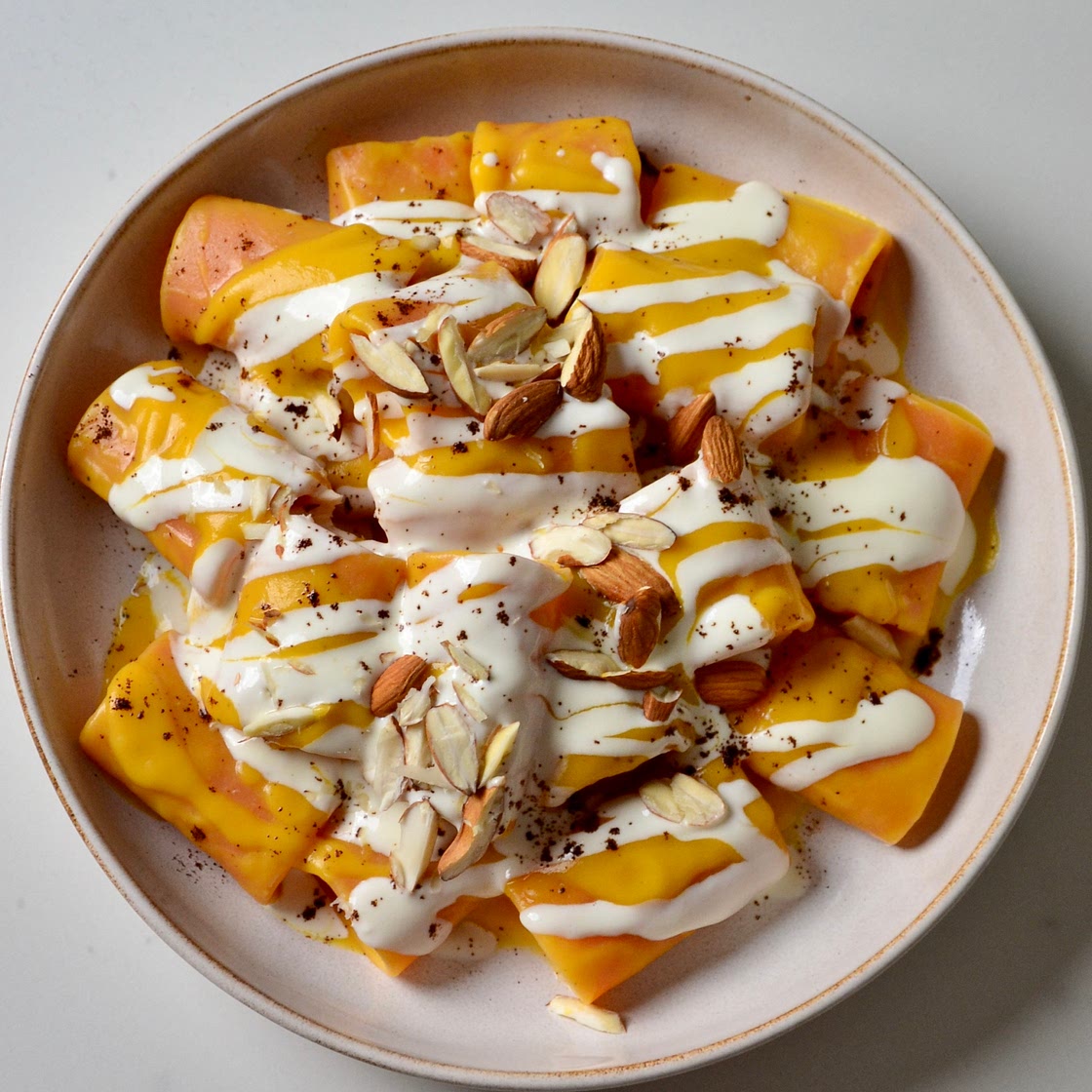 Pumpkin pasta with pecorino cheese, almonds and coffee