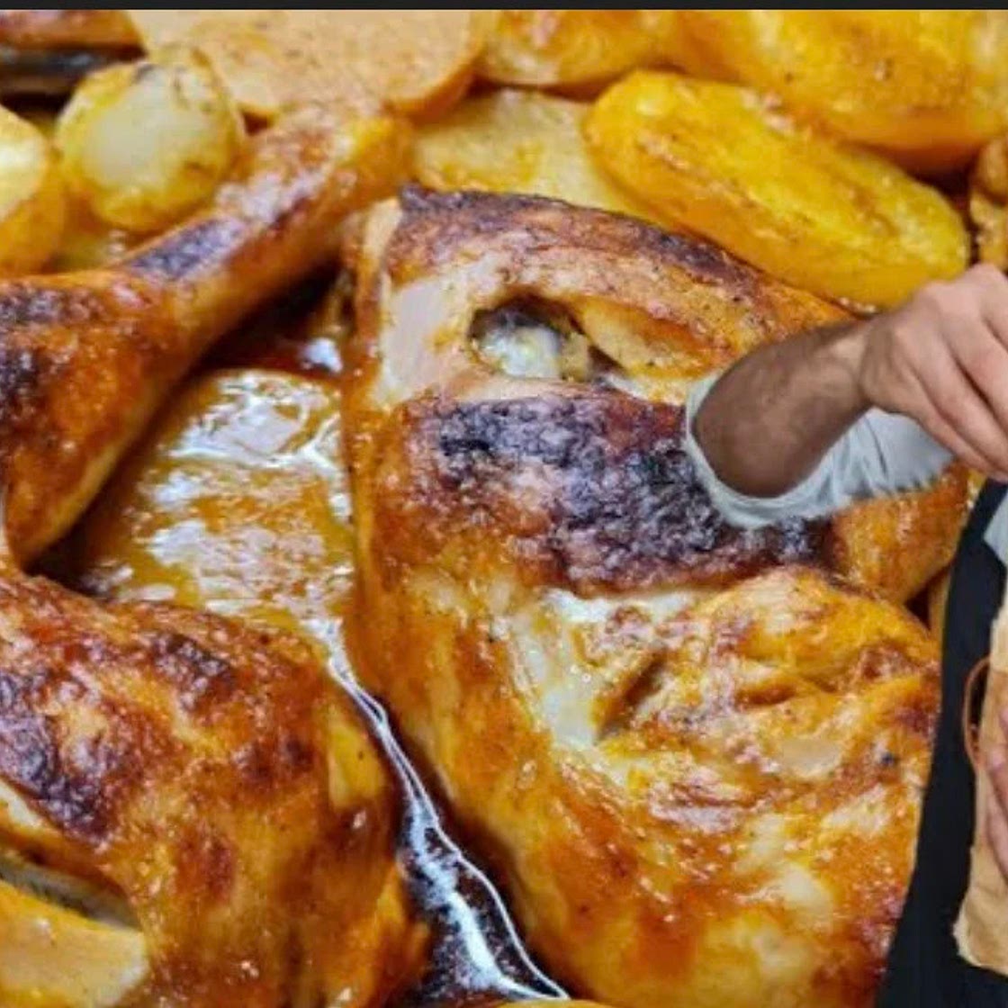 Tray of chicken with potatoes in the oven