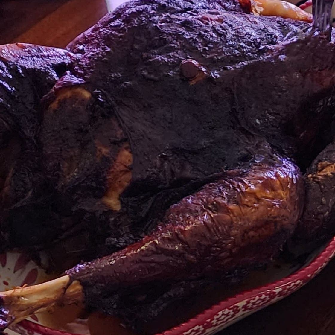 Smoked turkey in woodfire grill.