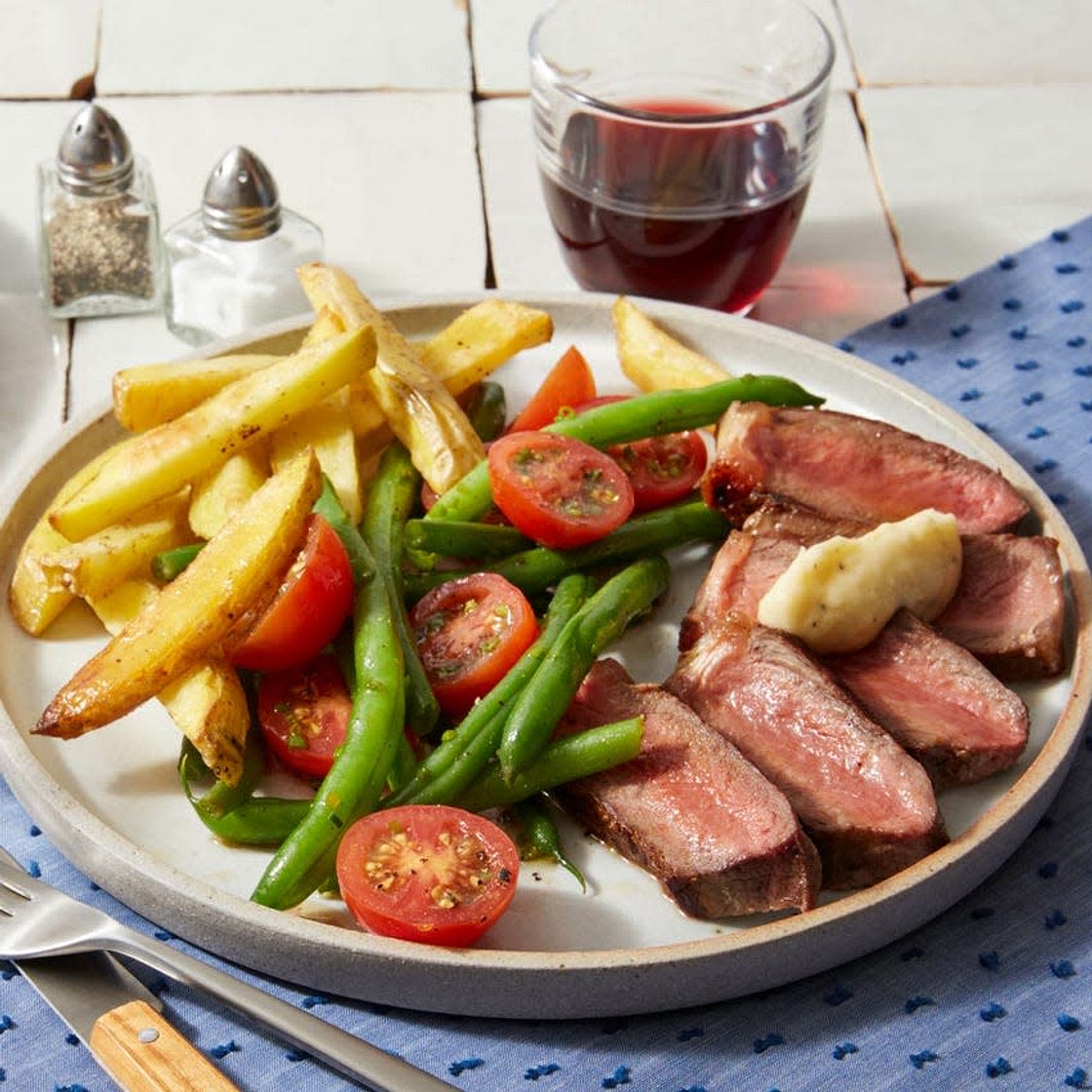 Strip Steaks & Garlic Butter with Oven Fries & Tomato-Green Bean Salad
