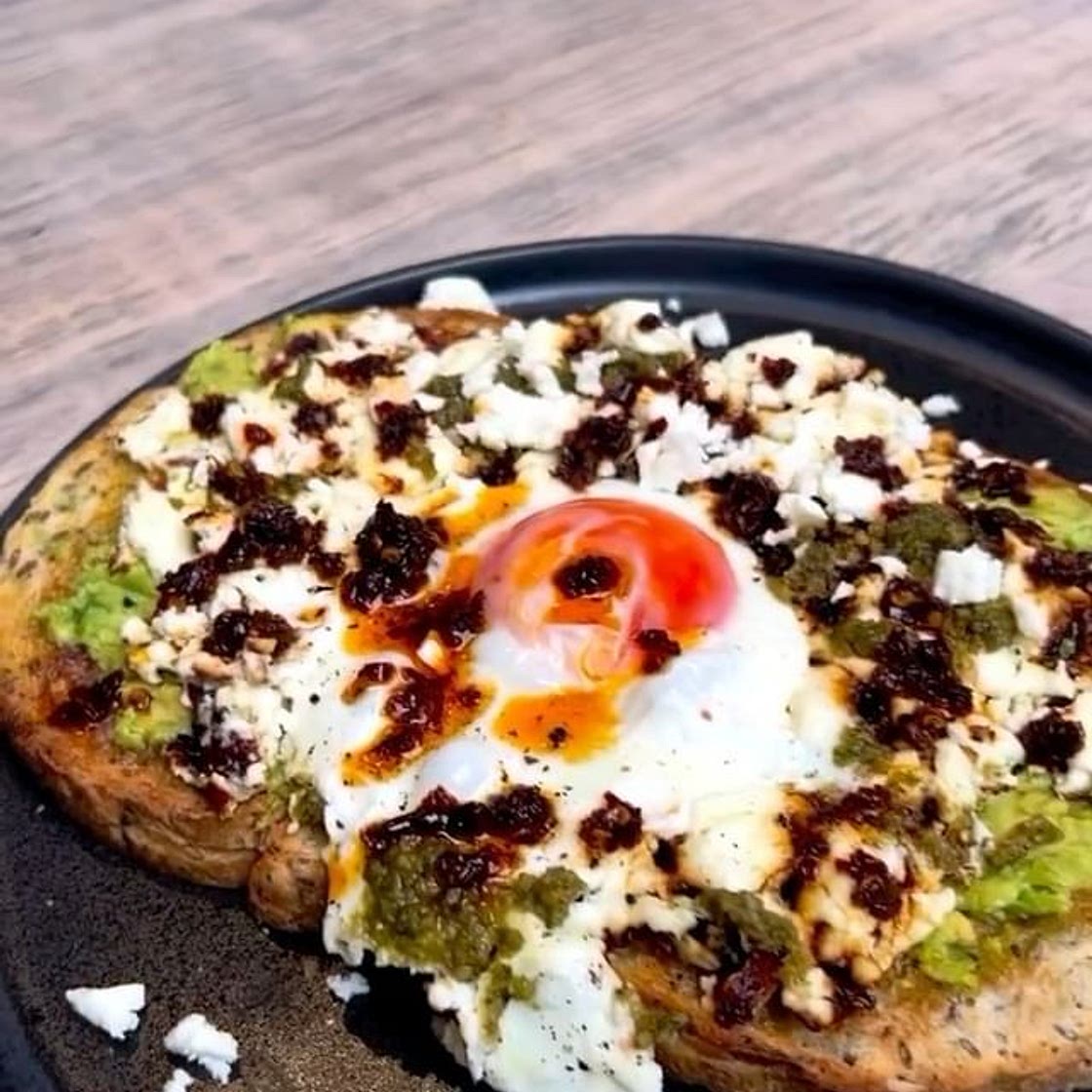 Crispy feta eggs with avocado, pesto & chilli oil