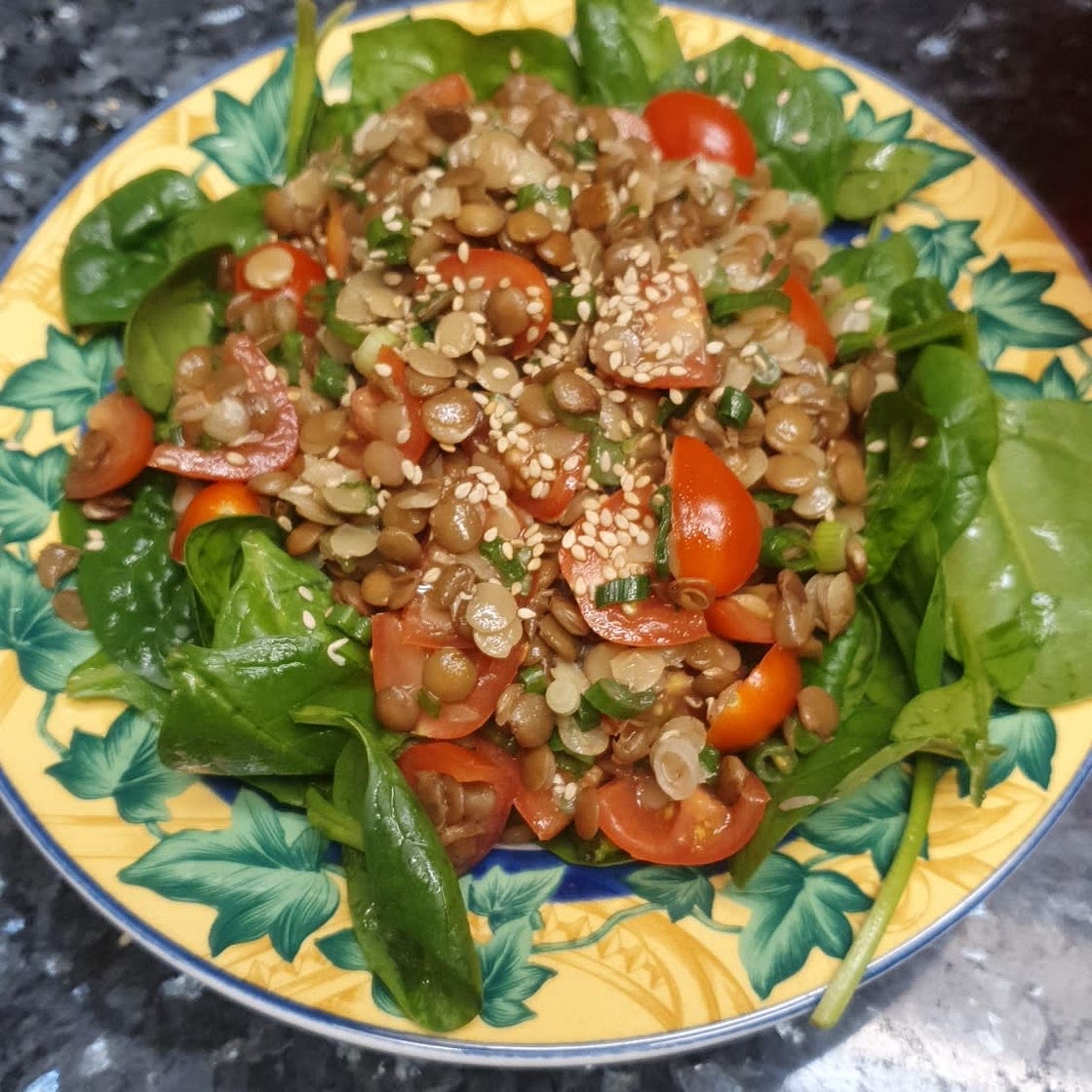 Warm lentil salad with baby spinach and walnuts