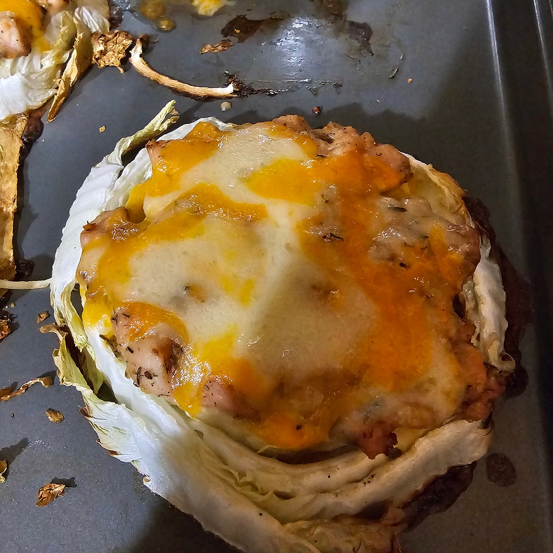 Cabbage slices covered with chicken and cheese.